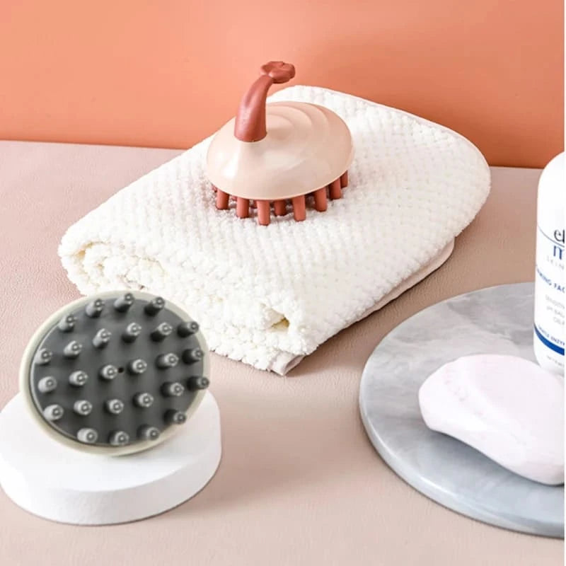 The image depicts a neatly arranged collection of relaxation and self-care products. It includes soft towels and massage tools, creating a calming and soothing atmosphere. The soft peach background enhances the sense of tranquility and relaxation.